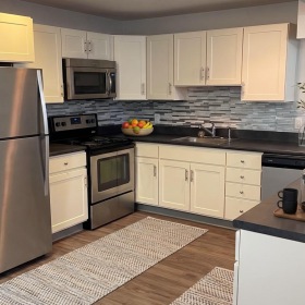 a kitchen with white cabinets