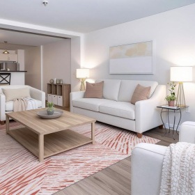 a living room with a couch, chairs and a coffee table